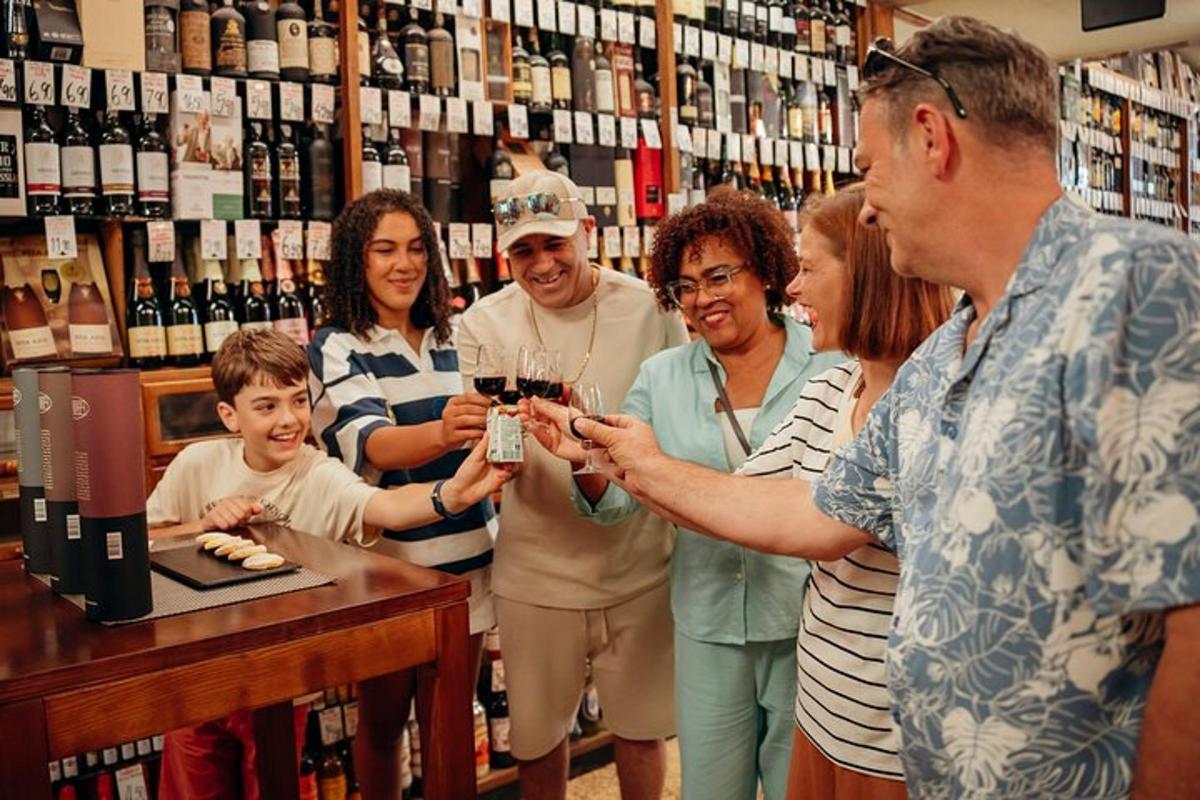 a group of people standing around a bar holding wine glasses
