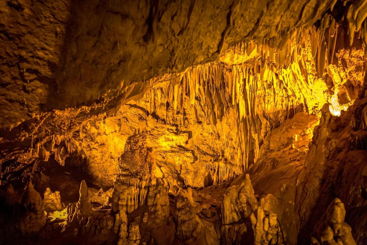 a cave with a wall of rock formations