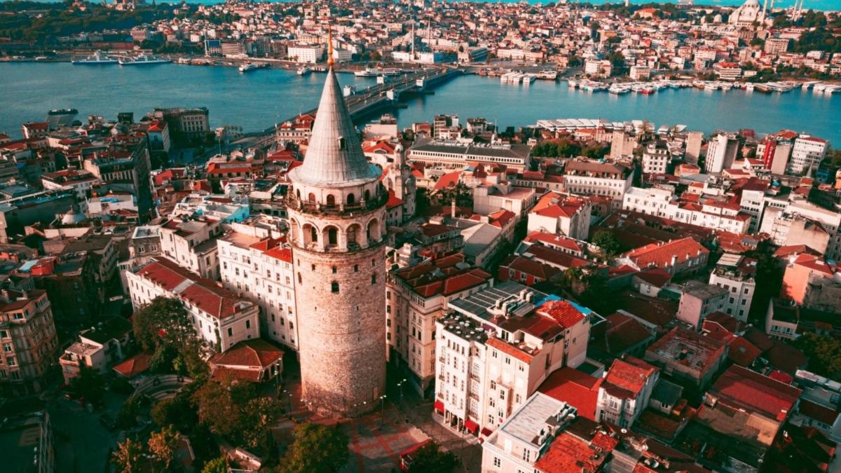 an aerial view of a city with a tall building
