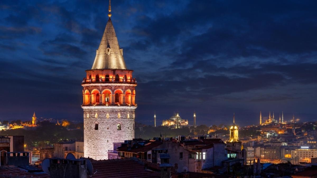 a tall clock tower with orange lights on it at night