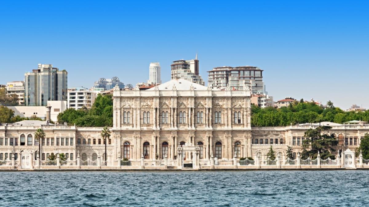 a building on the water in front of a city