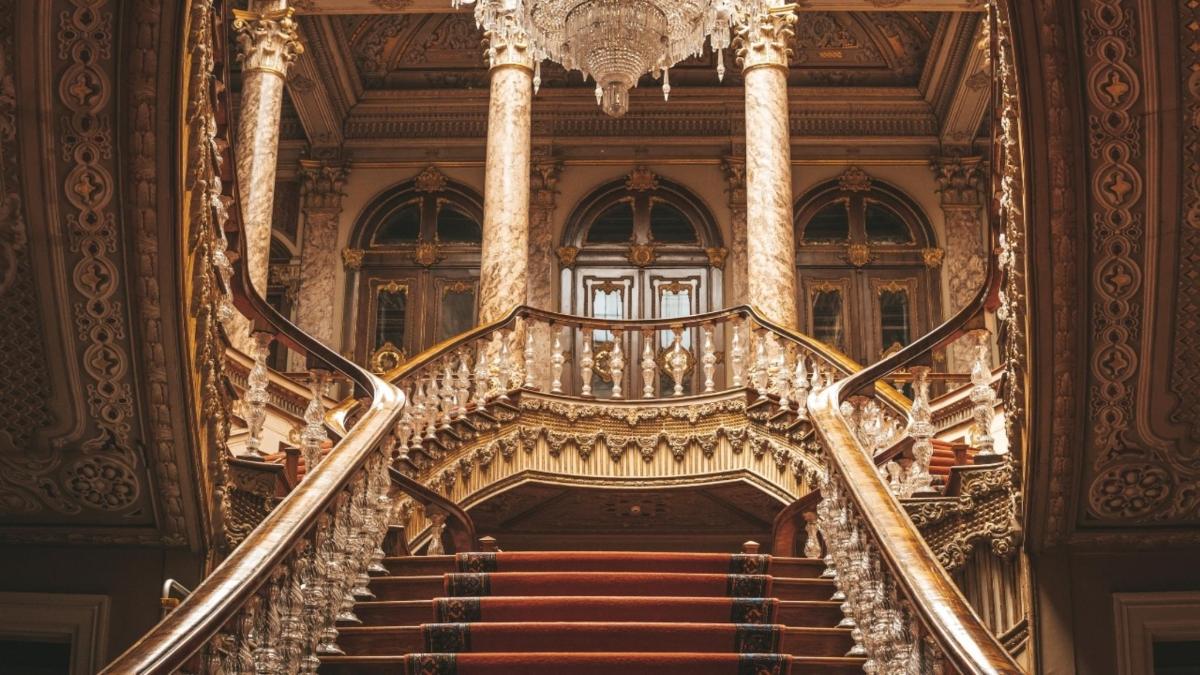 a spiral staircase in a building with a chandelier