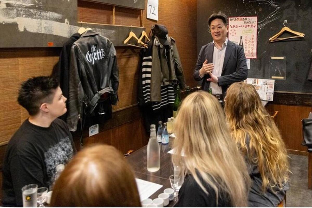 a man standing in a room with a group of people