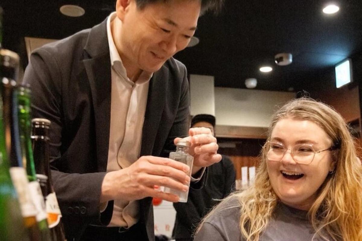 a man and a woman holding a glass of wine