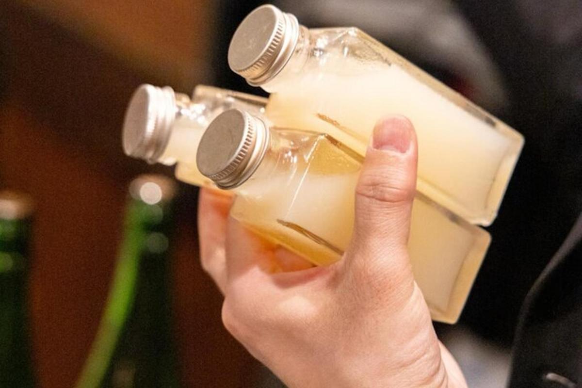 a person holding up a bottle of wine