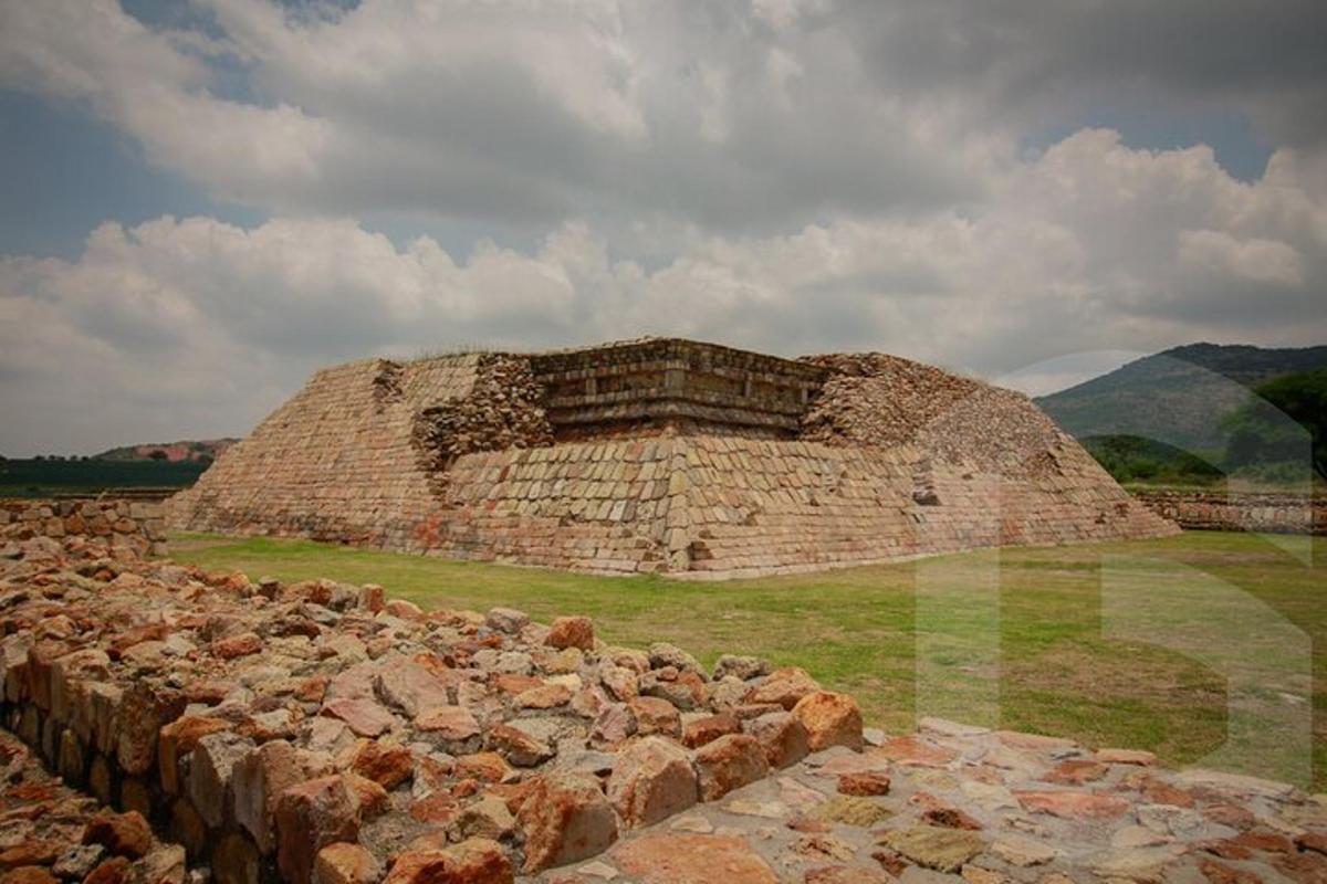 a large brick building with a pile of rocks