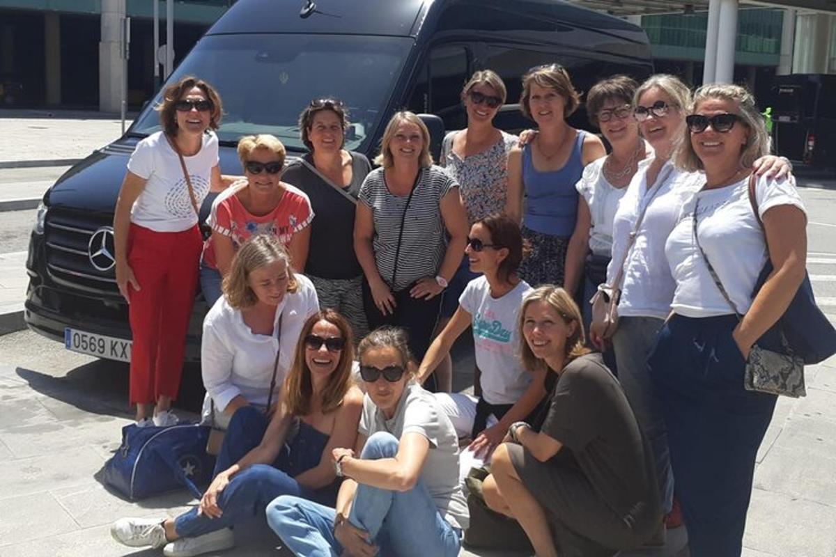 a group of women posing in front of a van