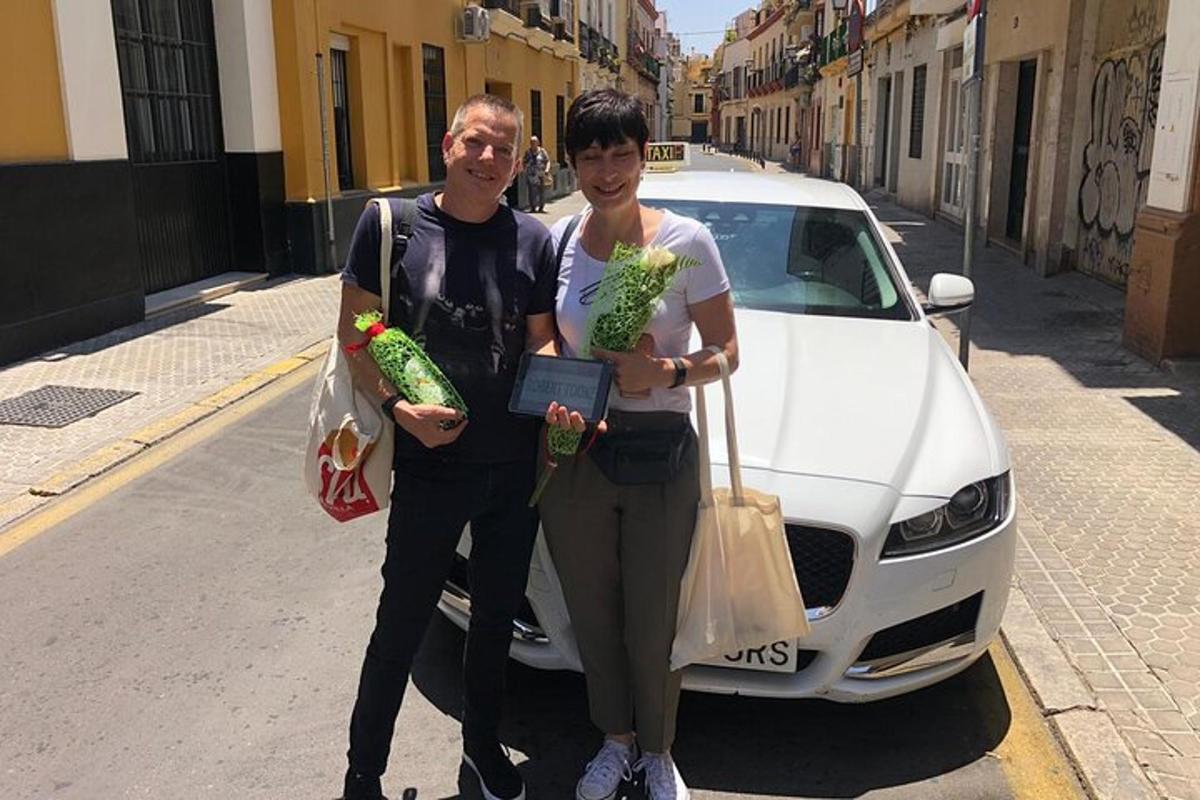 a man and a woman standing next to a white car