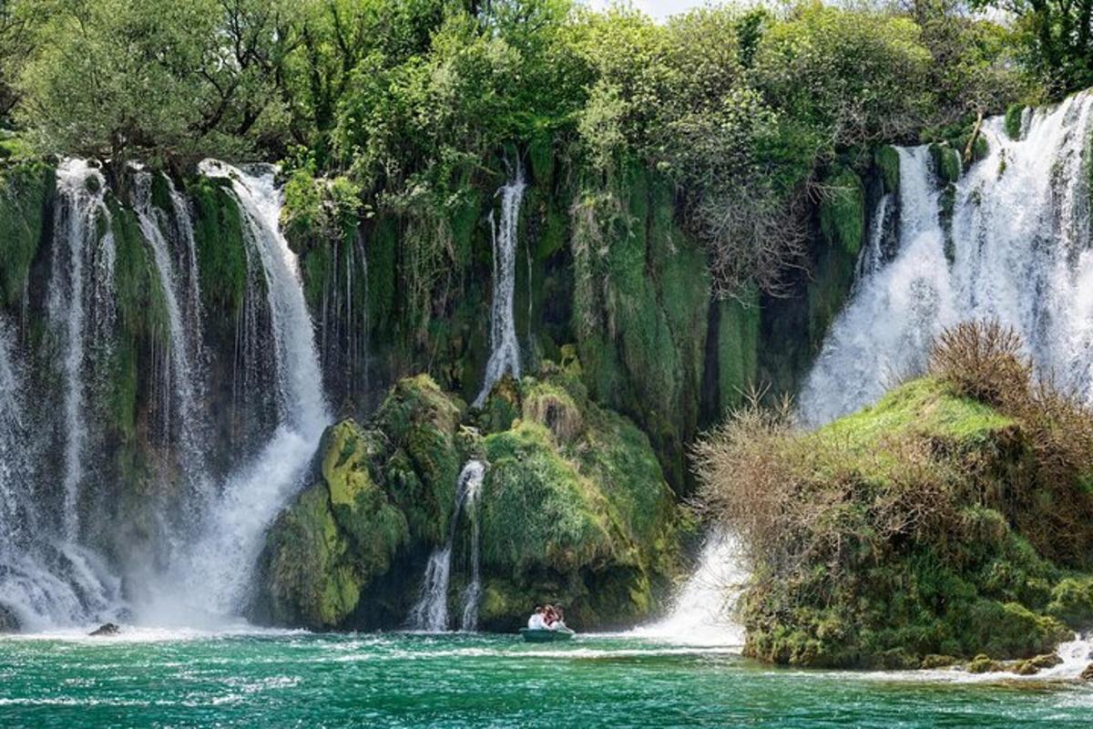 una barca in acqua davanti a una cascata