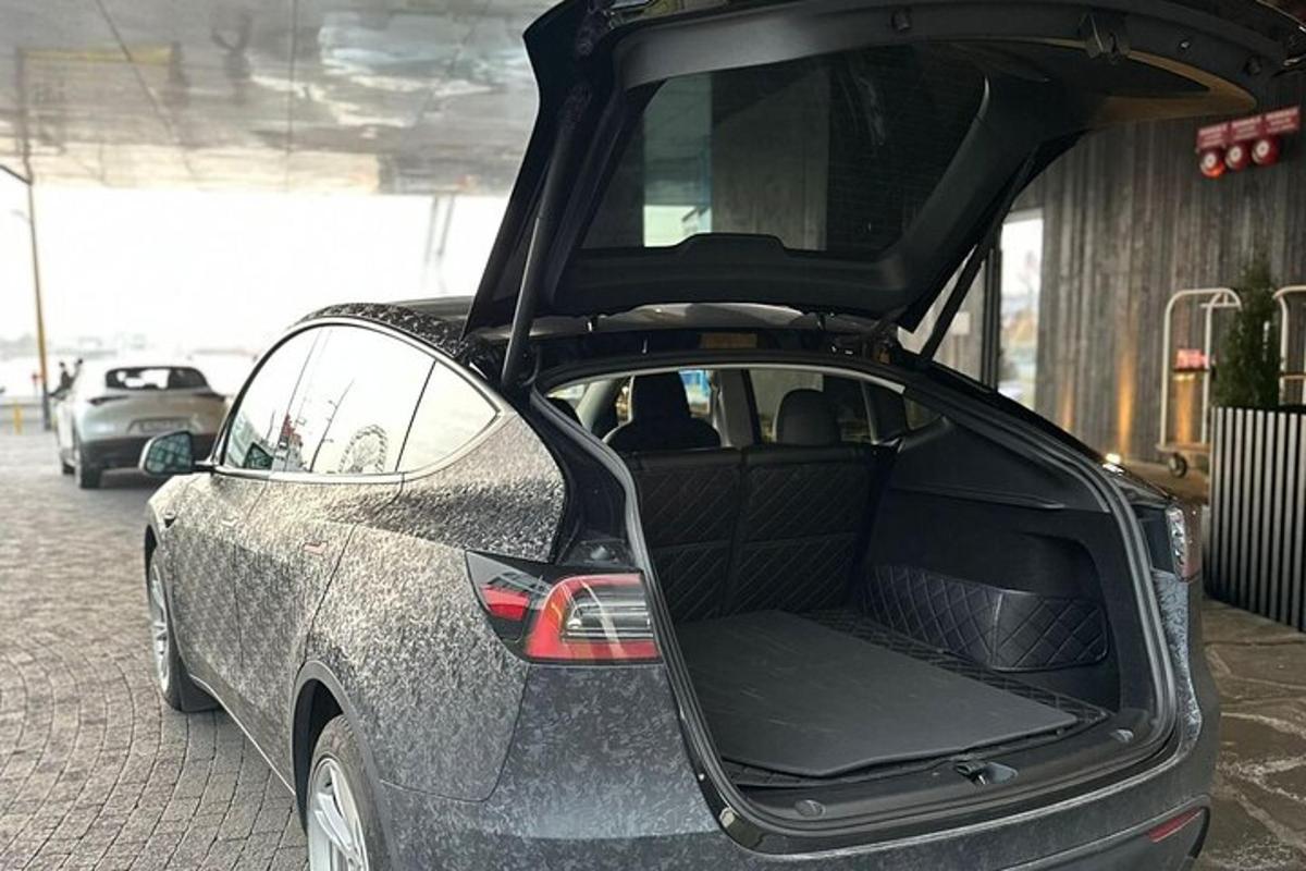 sebuah kereta dengan bagasinya terbuka di tempat letak kereta