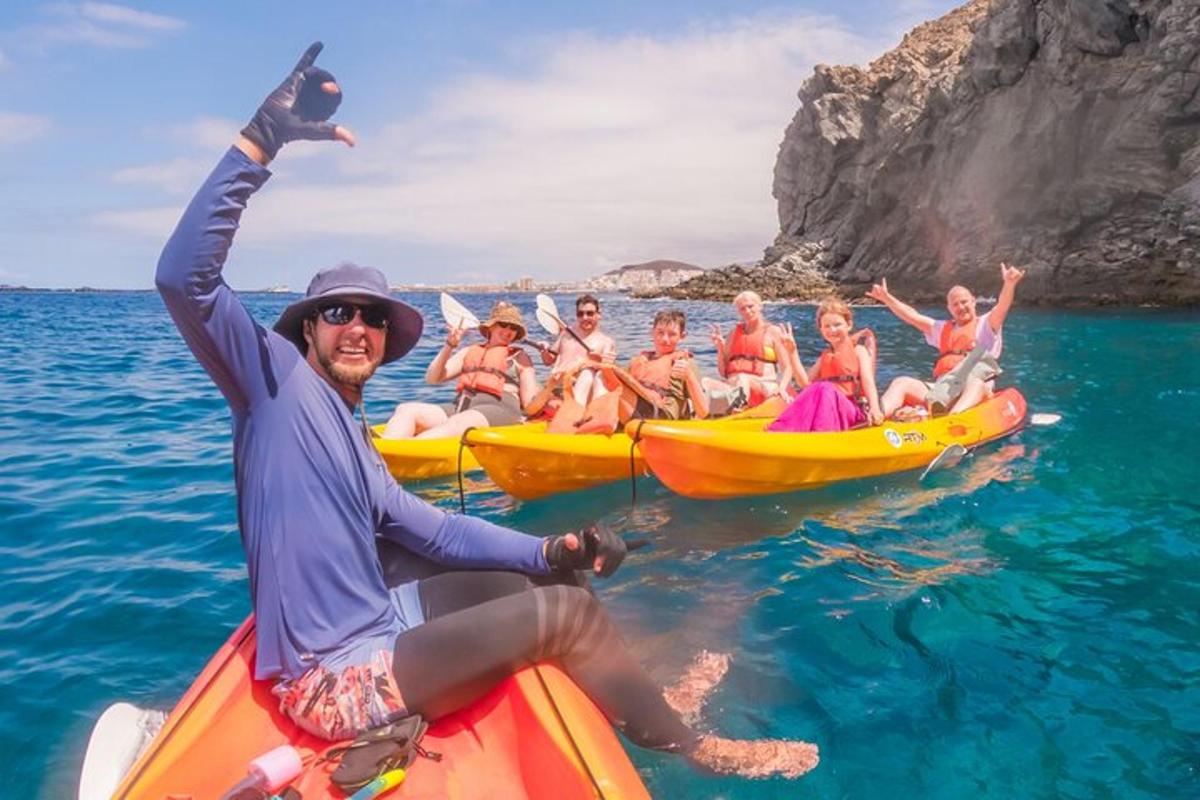 a group of people riding on kayaks in the water