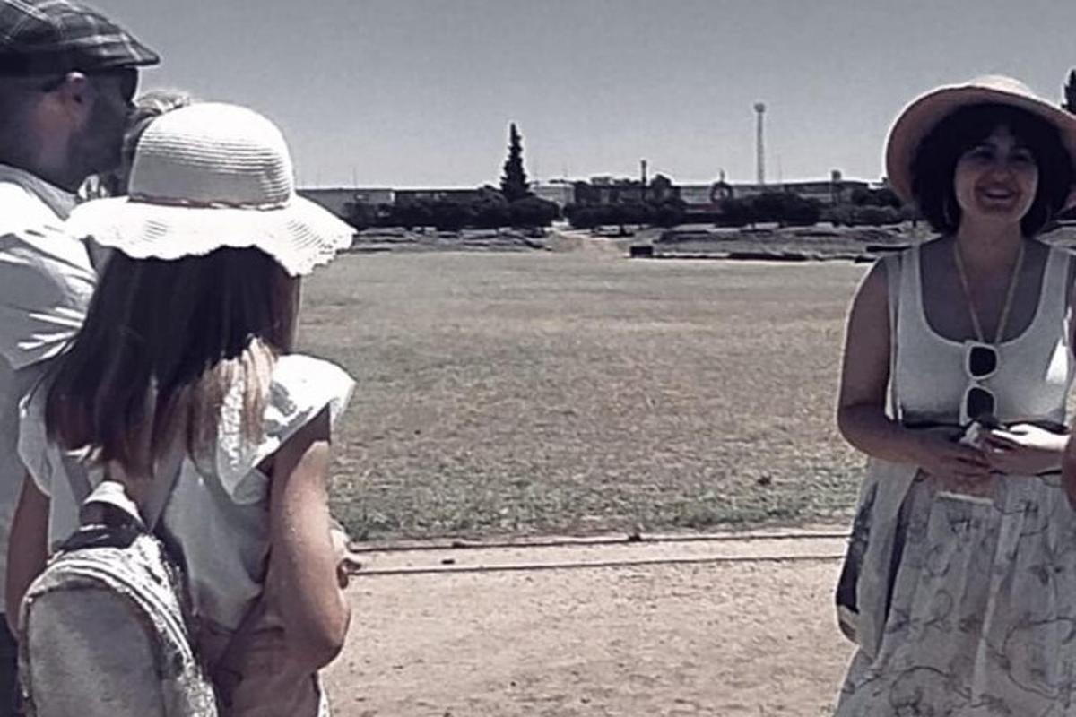 a man and a woman standing next to a field