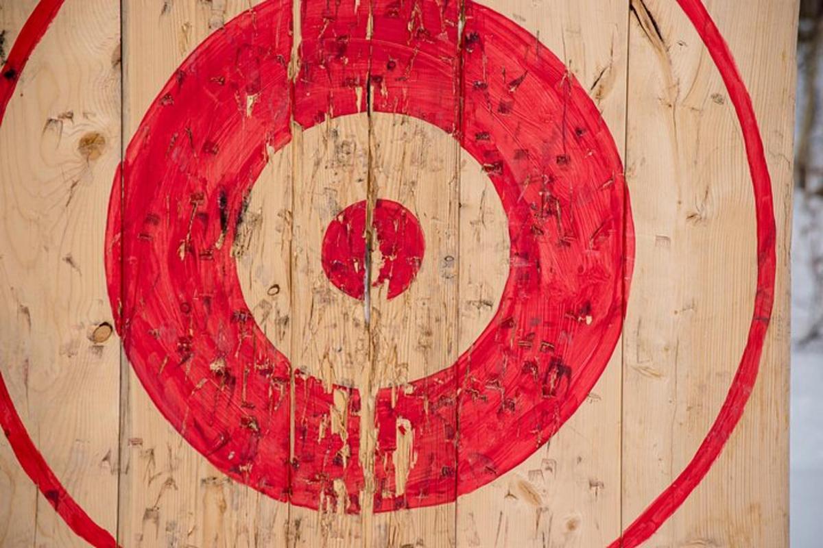 a red circle on the side of a wooden wall