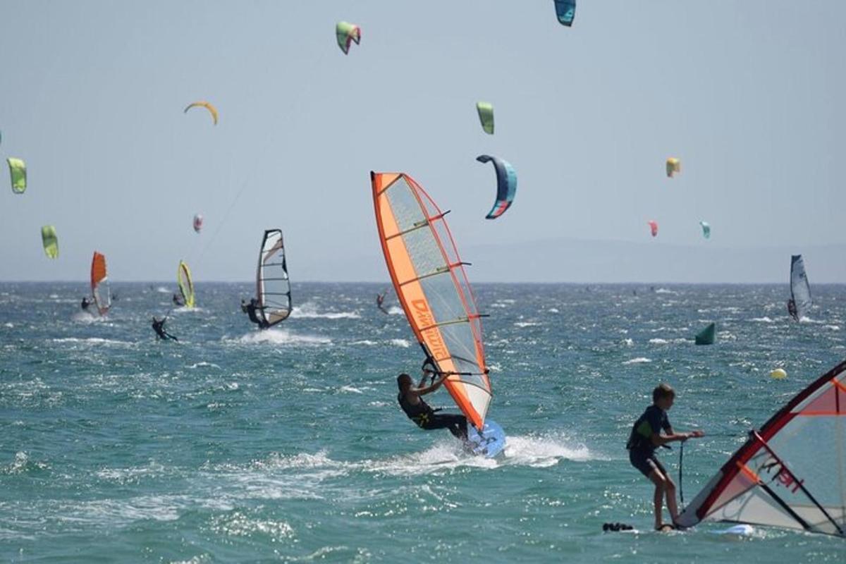a group of people windsurfing in the ocean