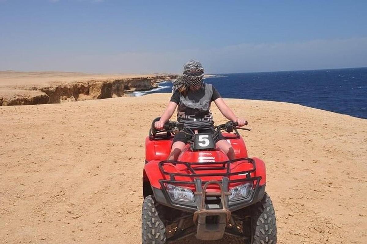 a person on a four wheeler on the beach
