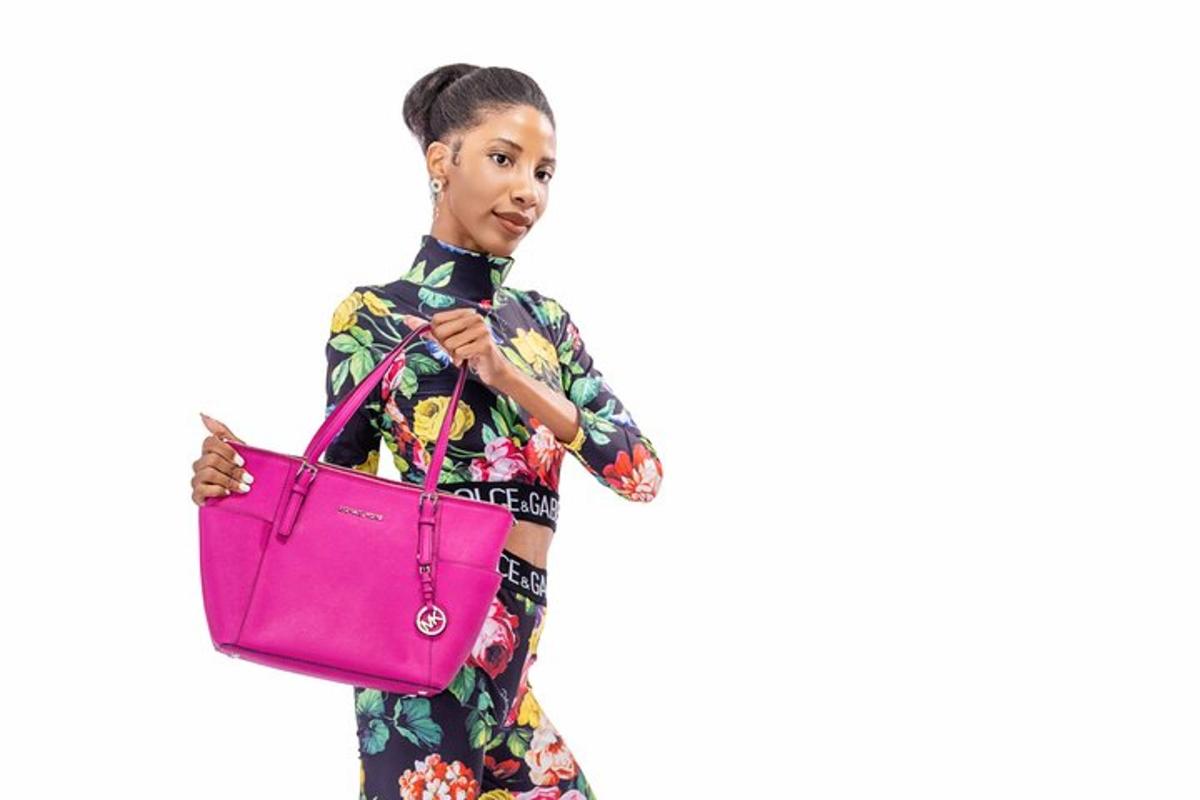 Una mujer joven sosteniendo un bolso rosa