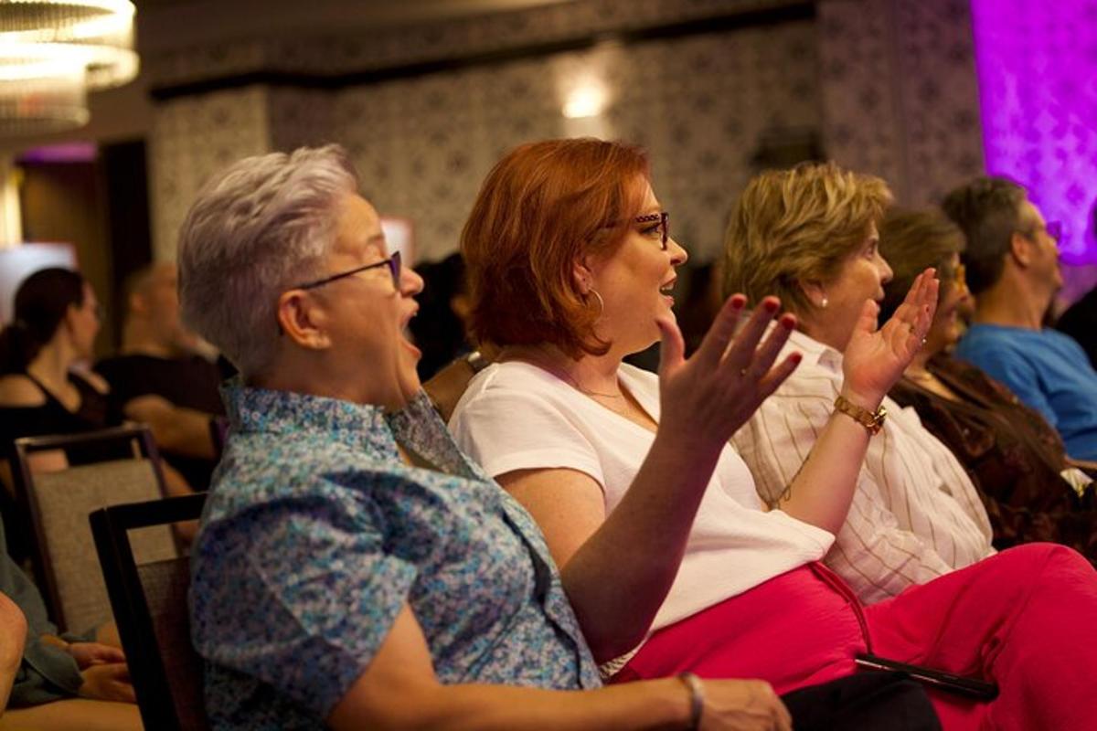 a group of people sitting in a crowd applaud