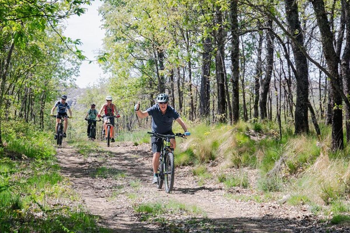 a group of people riding bikes down a dirt trail