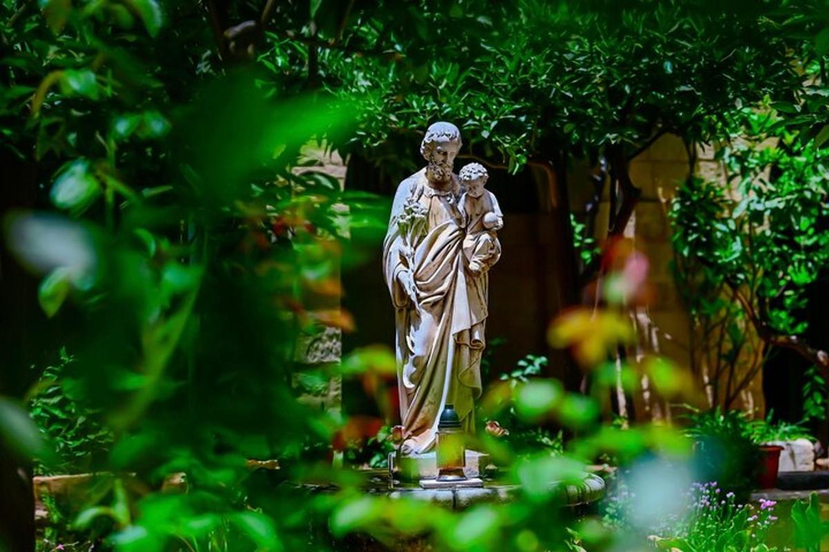 a statue of a woman in a garden