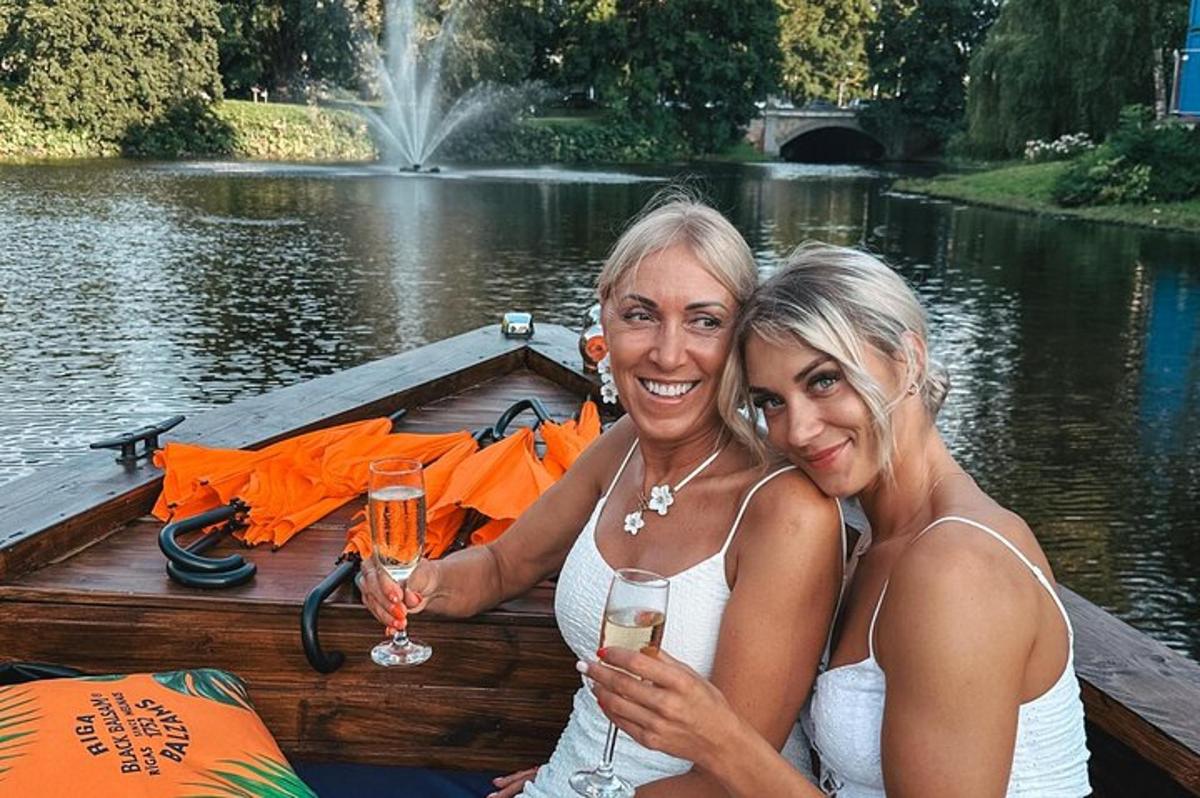 two women sitting on a boat with glasses of champagne