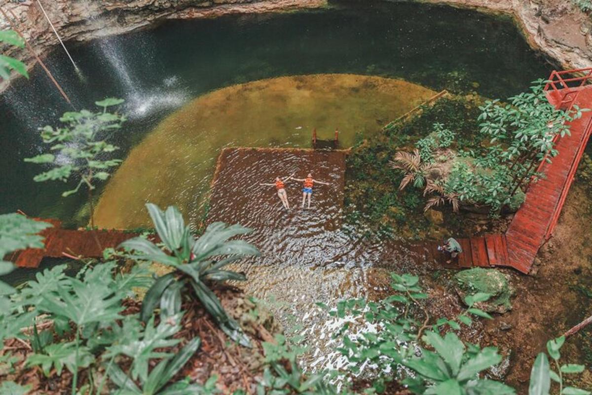 two people standing in front of a pool of water