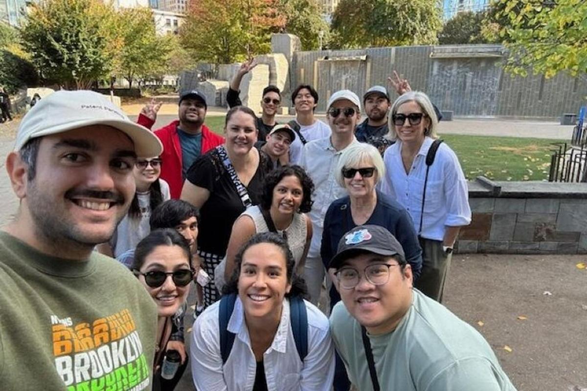 a group of people posing for a picture in a cemetery