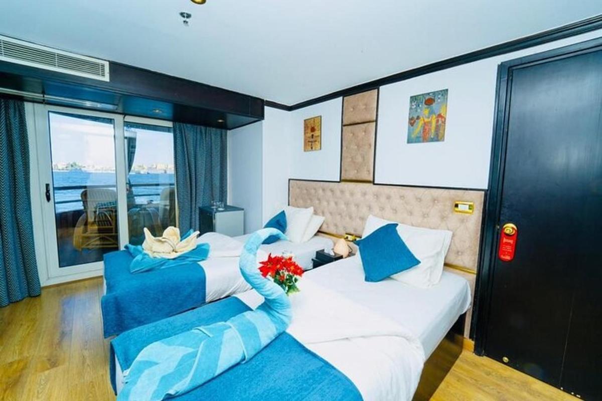 a hotel room with two beds and a balcony