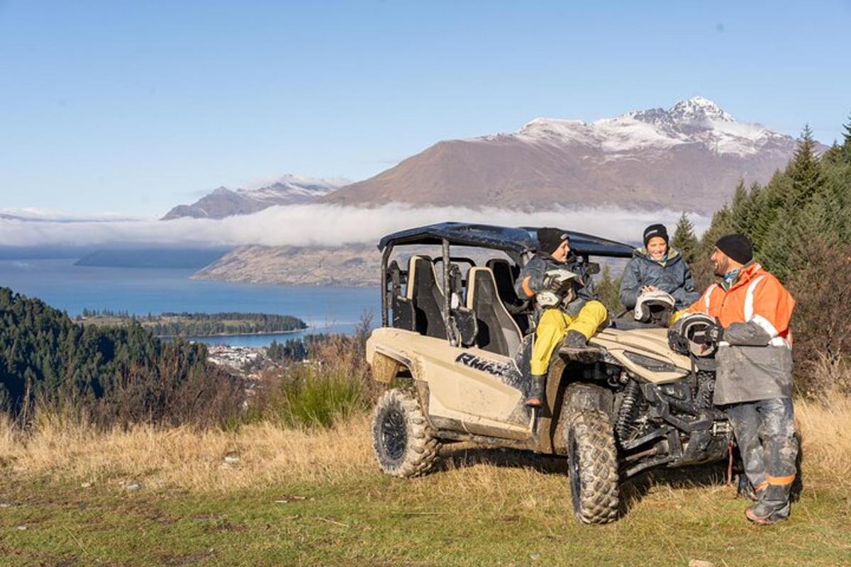 a group of people in a jeep on a hill