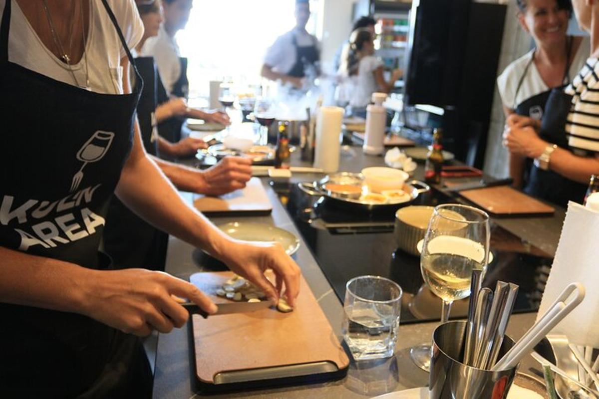 a group of people standing at a counter preparing food