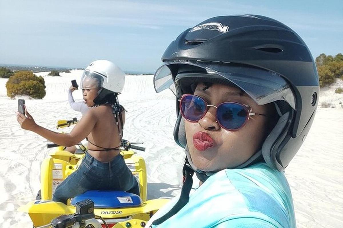 a woman riding on a snowmobile on the beach