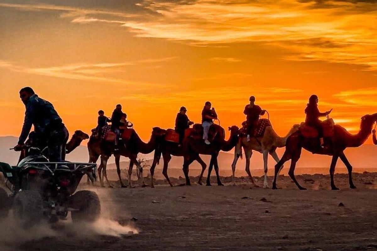a group of people riding horses on the beach at sunset