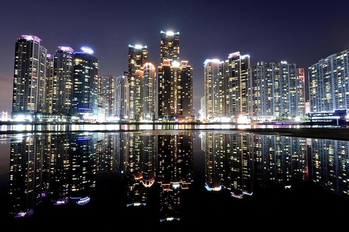 a large city at night with lights in the water