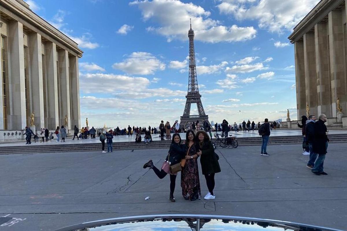 two women standing in front of the eiffel tower