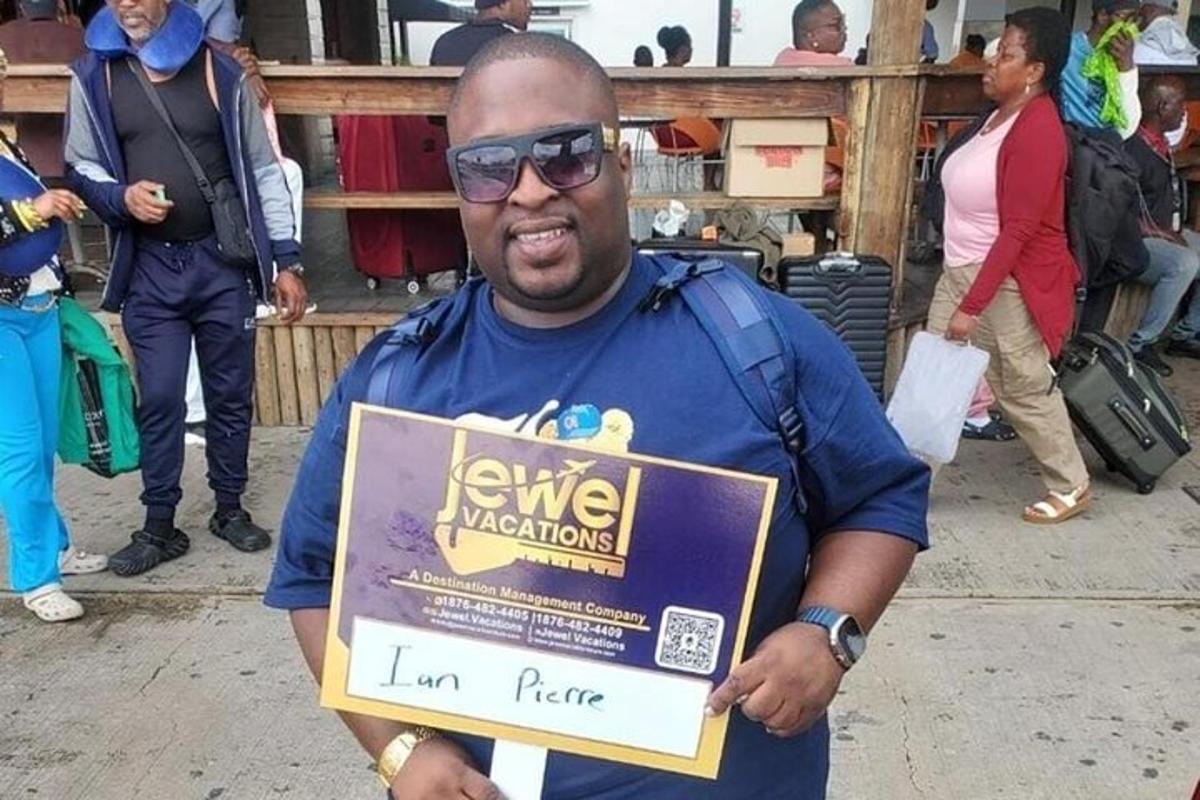a man holding a sign that says kenne inspections