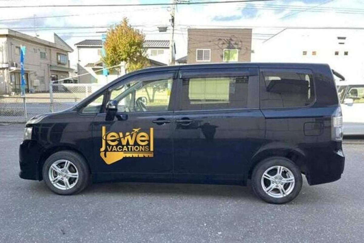 a black van with a yellow sign on the side of it
