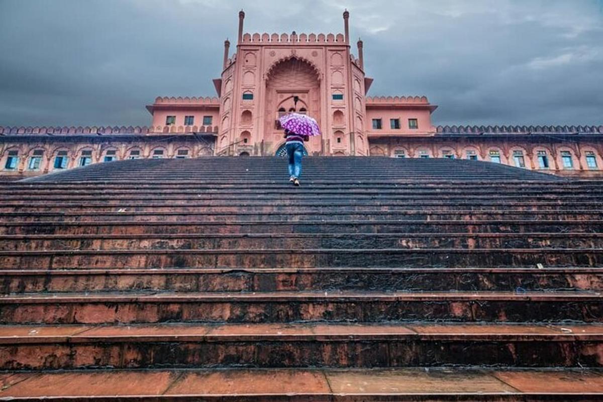 a person walking up some stairs with an umbrella
