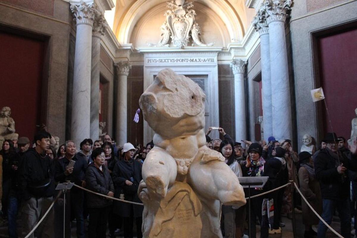 a group of people standing around a statue in a building
