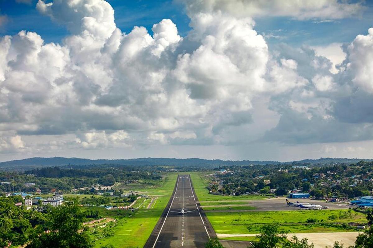 an aerial view of an airport runway with clouds