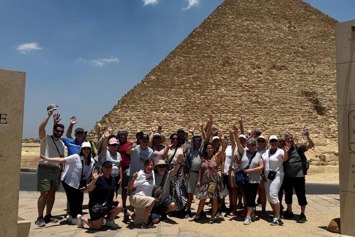 a group of people posing in front of a pyramid