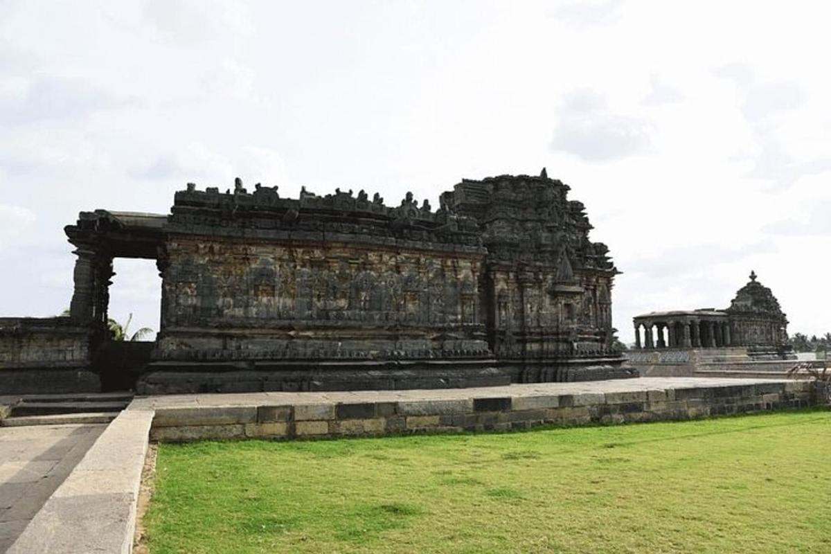 a large stone building with a green field in front