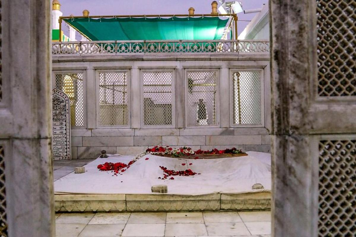 a fountain in a building with red flowers on it