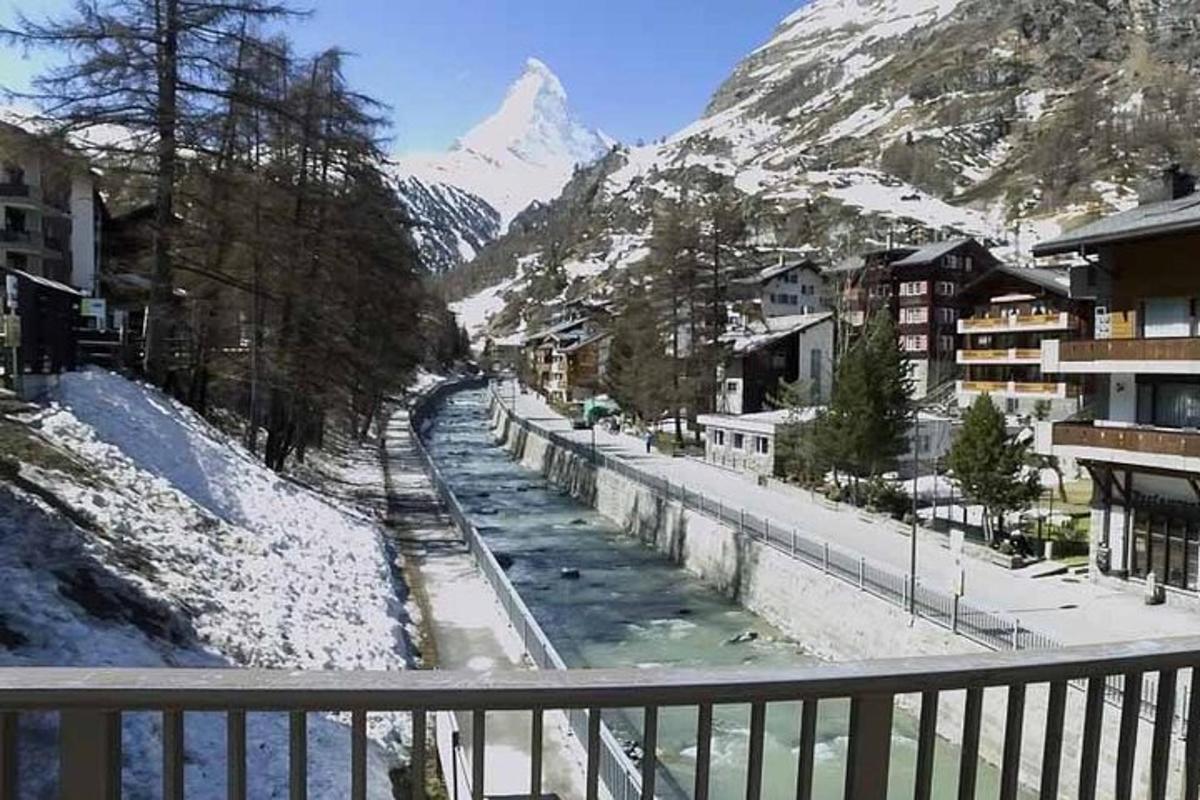 a view of a snow covered mountain from a balcony