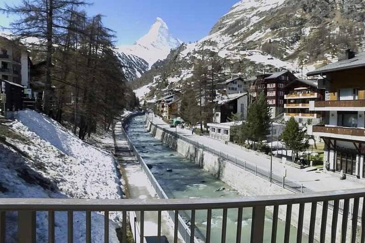uma vista de uma montanha coberta de neve de uma varanda