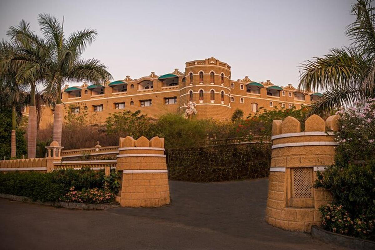 a large building with palm trees in front of it