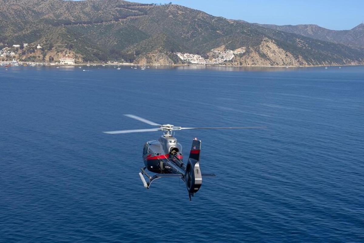 a helicopter flying over a body of water