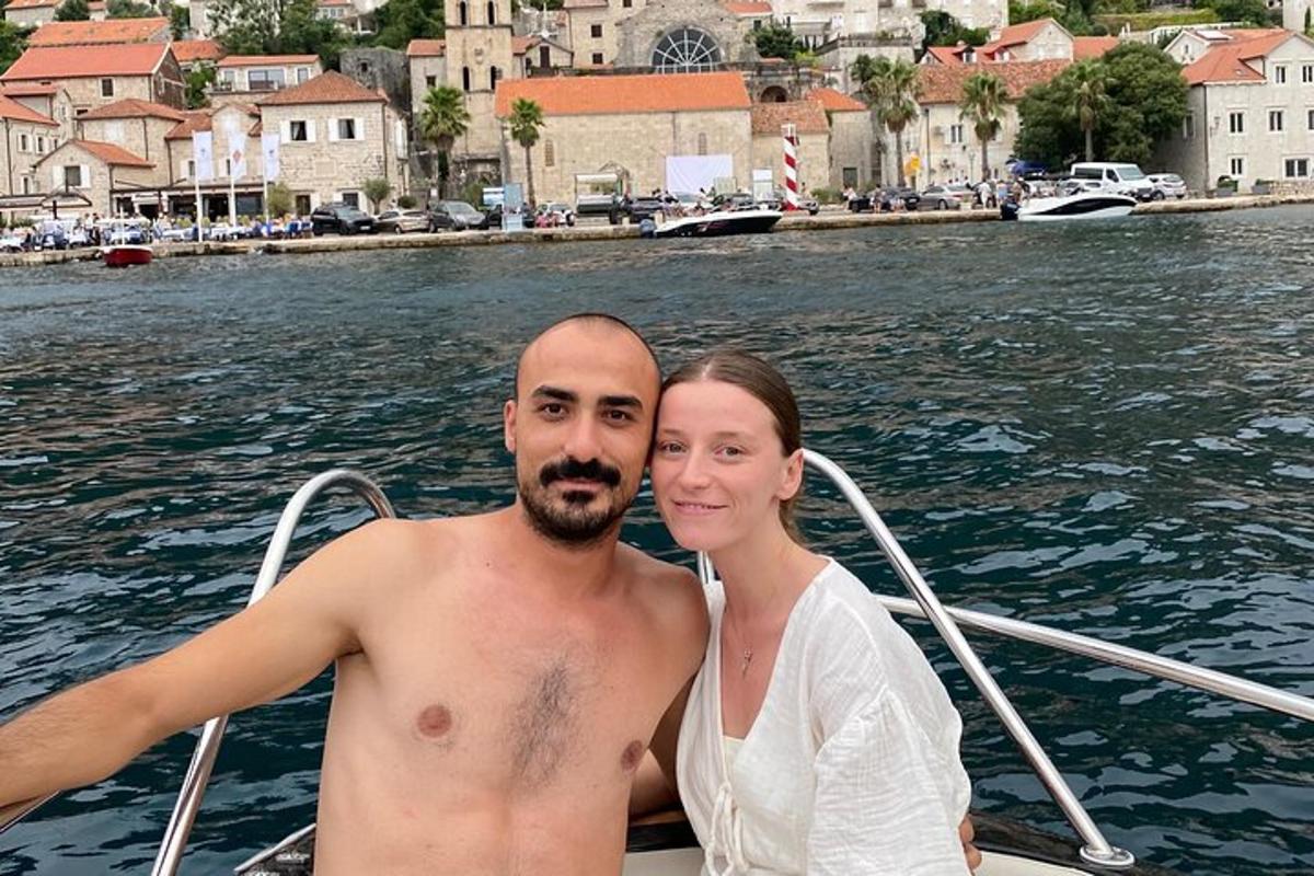 a man and a woman on a boat in the water