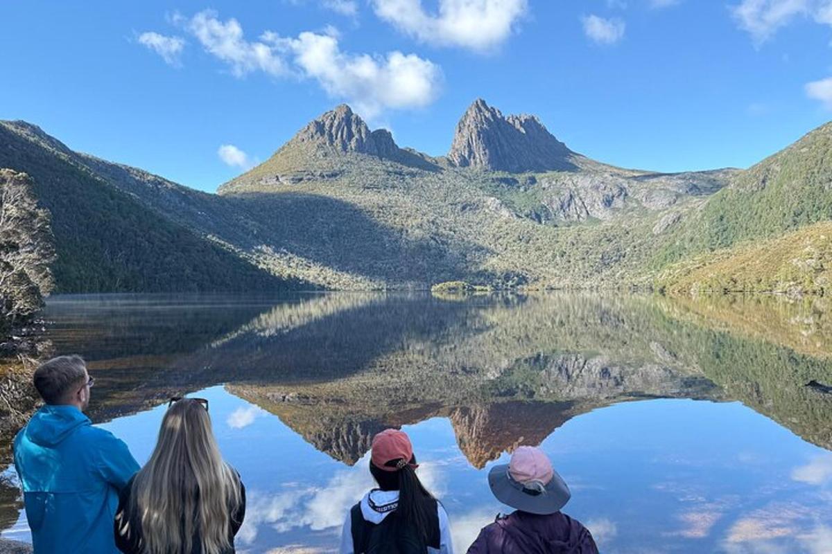 a group of people sitting in front of a lake