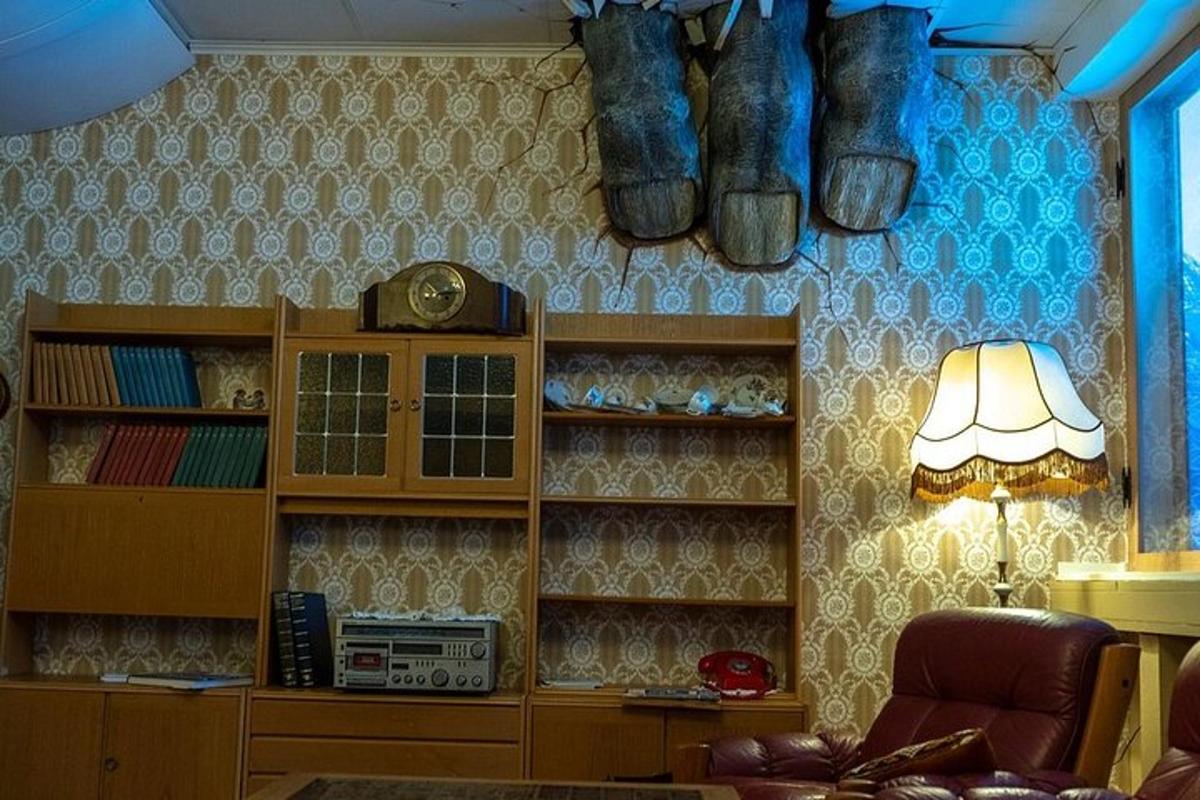 a living room with a shelf with boots on the wall