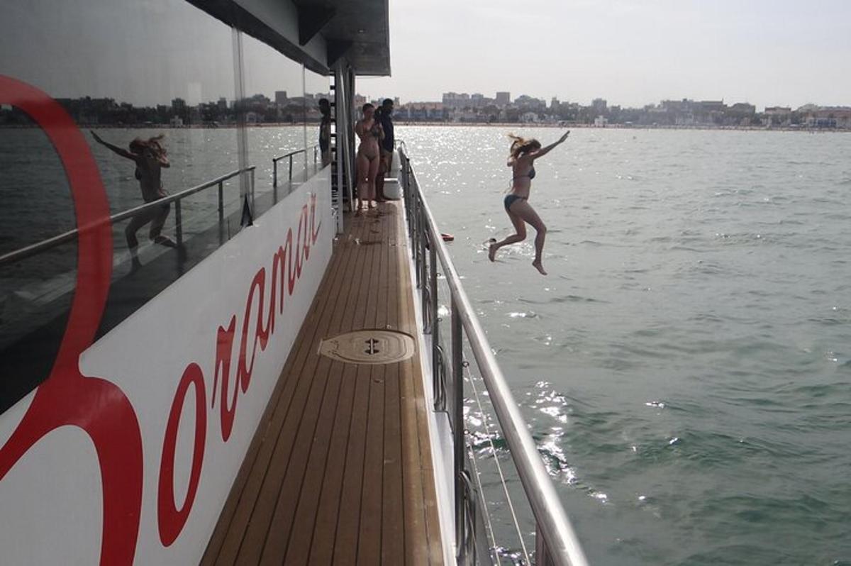 a woman jumping into the water from a boat