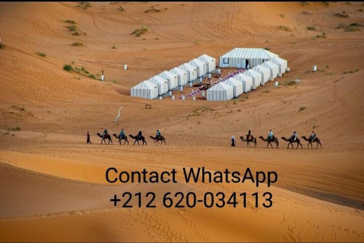 a group of people riding horses in the desert